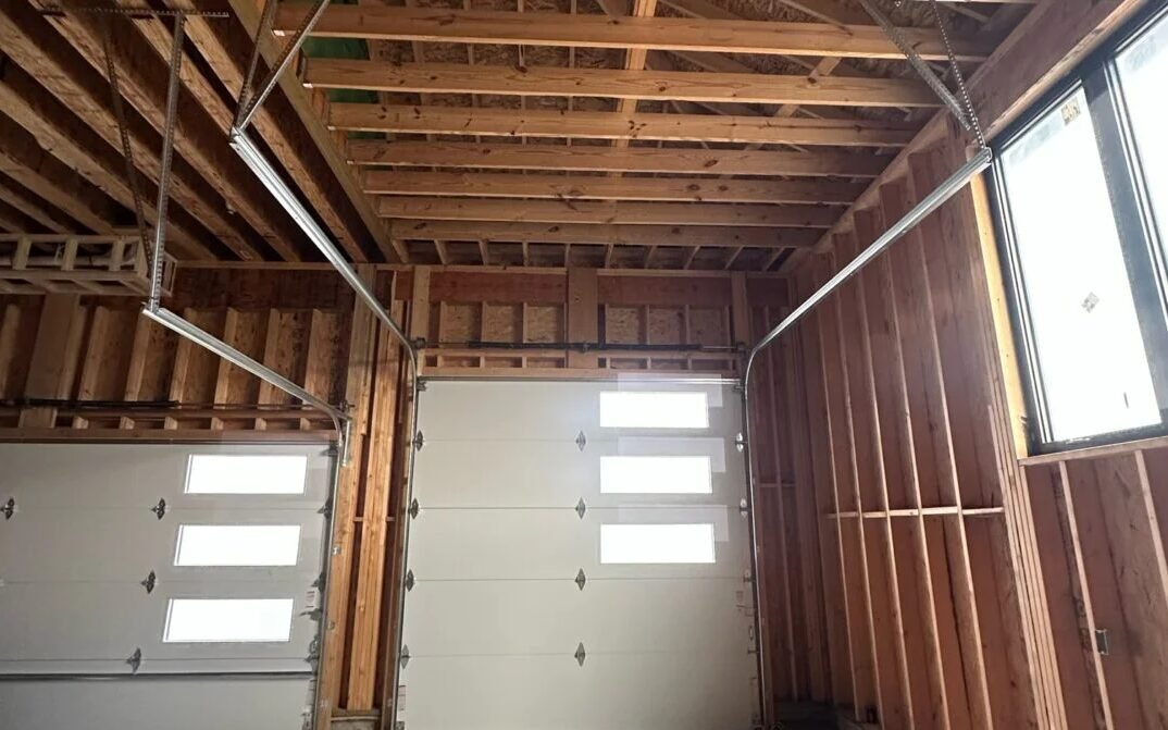 An experienced technician from Local Garage Door Repair Englewood FL performing a garage door repair on a residential home, showcasing tools and techniques for efficient service.