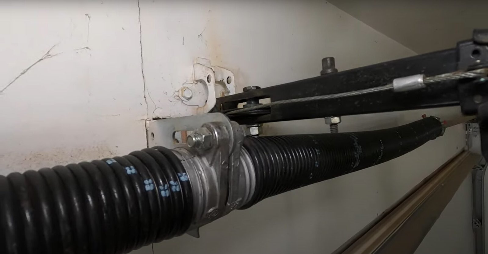 Technician performing garage door spring repair in Englewood, FL, ensuring smooth and safe door operation for local homeowners.