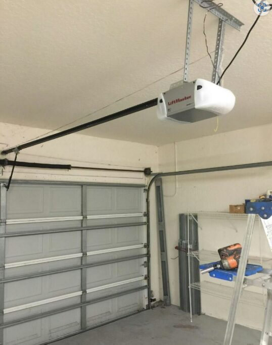 Technician performing garage door opener repair in Englewood, FL with advanced tools